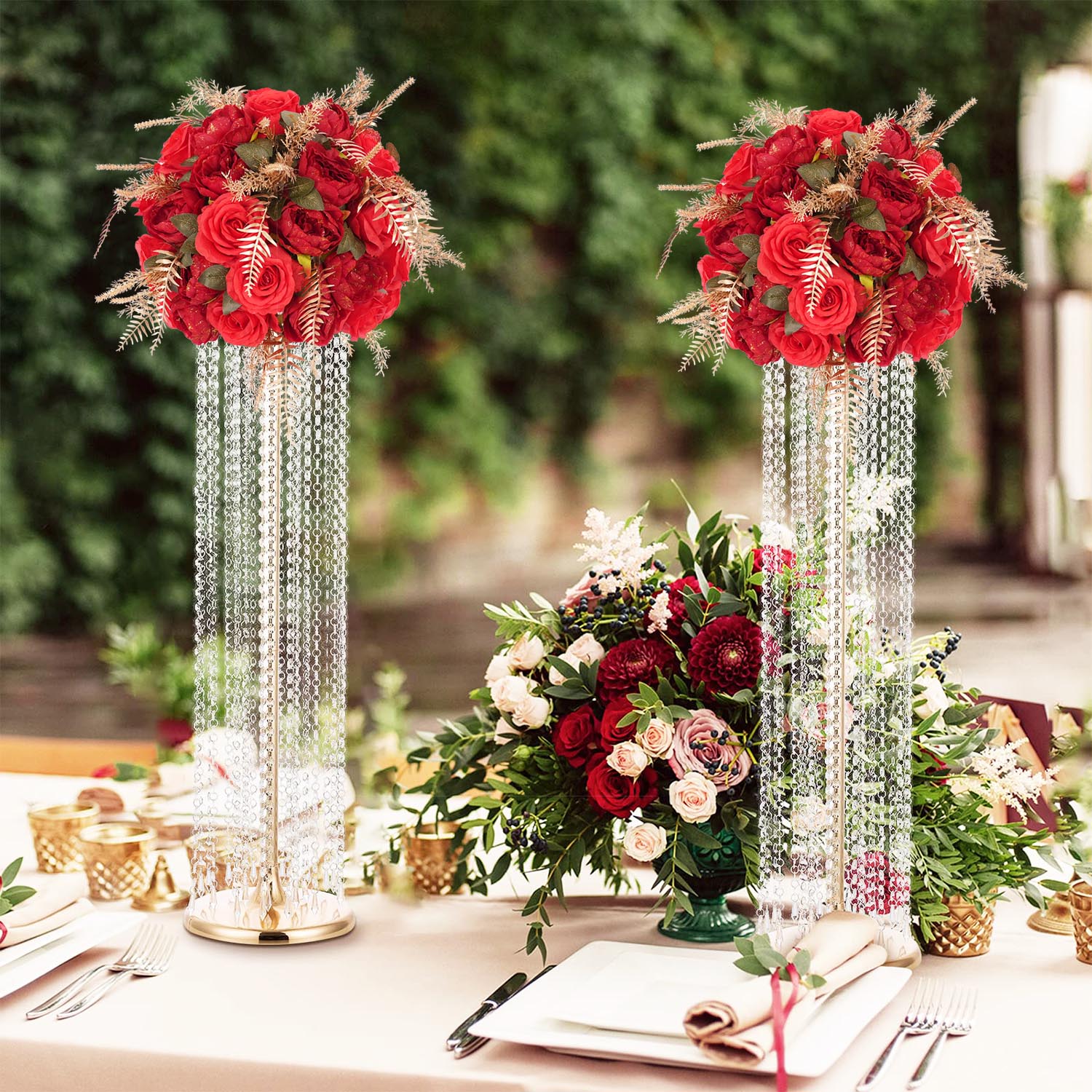 Burgundy wedding table setting with gold cutlery and candlelight